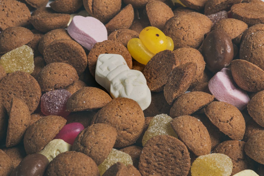 Close-up of traditional Dutch Sinterklaas treats featuring kruidnoten and colorful candies.